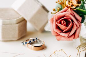 Wedding flay lay photo with rings, ring box, and flowers