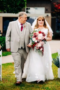 Bride walking down aisle with her father at Kwataqnuk Resort wedding