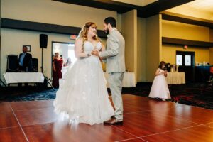 Bride and groom first dance in the reception hall ballroom at Kwataqnuk Resort in Polson, Montana