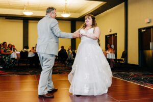 Father daughter dance in reception hall ballroom at Kwataqnuk Resort in Polson, MT