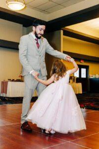 Father dancing with daughter during wedding reception at Kwataqnuk Resort in the ballroom