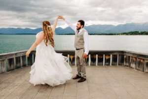 Bride and groom dancing on the dock to Flathead Lake at Kwataqnuk Resort in Polson, Montana