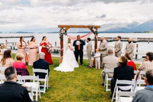 Outdoor wedding ceremony at Kwataqnuk Resort with Flathead Lake in background