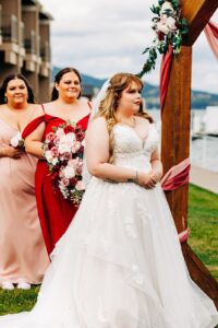 Bride and bridesmaids during wedding ceremony at Kwataqnuk Resort in Polson, MT