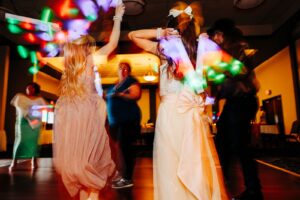 Wedding dance photo with glow sticks and intentional blur at Kwataqnuk Resort in Polson, MT