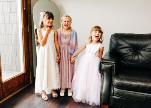 Flower girls smiling and holding hands