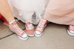 Photo of pink Converse shoes on bride and bridesmaids