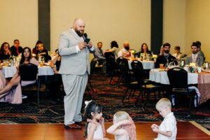 Best man giving speech during wedding reception at Kwataqnuk Resort