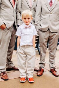 Ring bearer with pink bowtie and red shoes