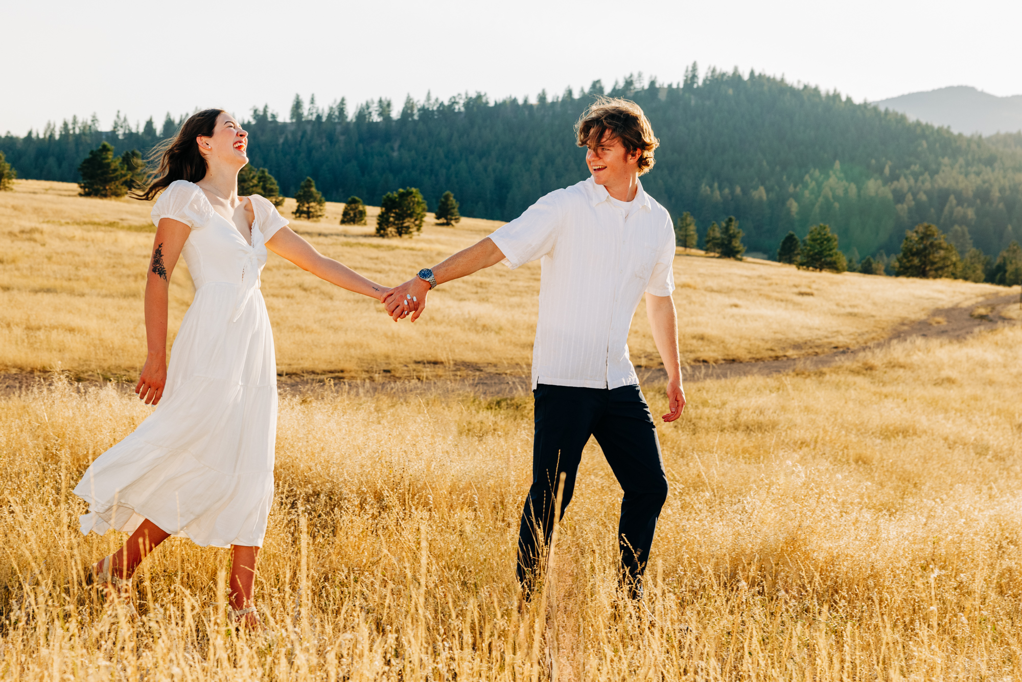 Engagement photo showing Montana couple holding hands at Blue Mountain Trailhead in Missoula