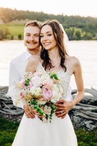 Portrait of bride and groom with flower bouquet at Flathead Lake Forevers in Big Arm, MT