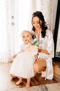 Bride getting her baby daughter dressed for wedding at Flathead Lake Forevers