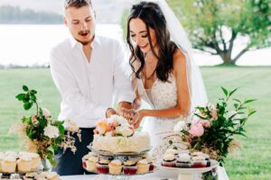 Bride and groom cutting cake with Flathead Lake in background