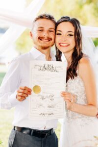 Montana bride and groom holding up marriage license