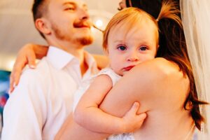 Bride and groom slow dancing with baby daughter at Flathead Lake Forevers in Big Arm, MT