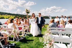 Bride and groom exit after wedding ceremony at Flathead Lake Forevers