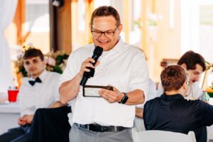 Father of groom delivering speech at Flathead Lake Forevers wedding reception