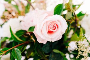 Detail photo of pink rose in wedding floral bouquet