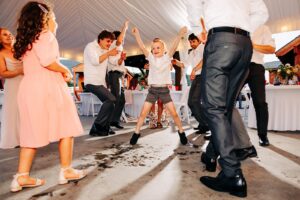 Little boy jumping on dance floor during wedding reception at Flathead Lake Forevers