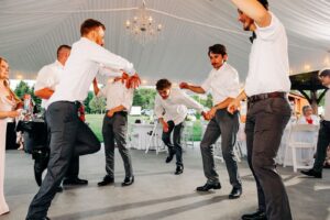 Groom and groomsmen dancing at Flathead Lake Forevers wedding reception