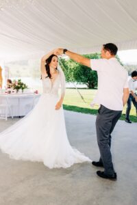 Father daughter dance at in white reception tent at Flathead Lake Forevers