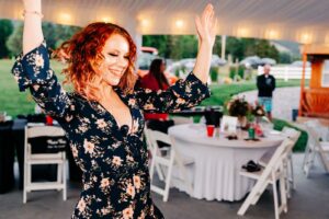 Redhead wedding guest dancing at Flathead Lake Forevers wedding reception