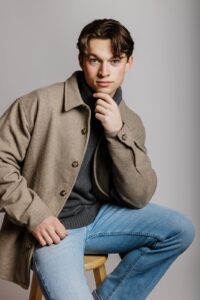 Professional studio portrait of male model in jeans and coat