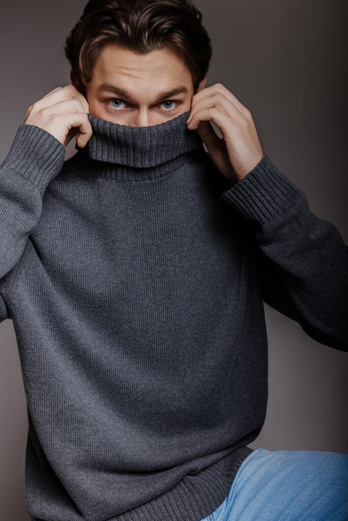 Playful studio portrait of male model in turtleneck