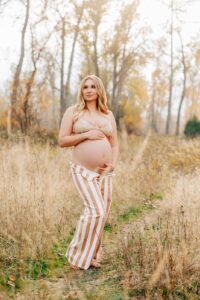 Maternity photo pregnant woman in striped jeans in nature