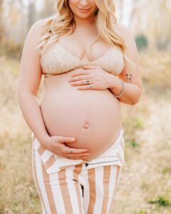 Close up pregnant woman's bare baby bump