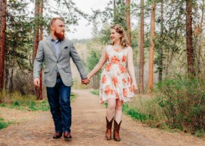 Missoula couple holding hands at Lincolnwood Trailhead in Missoula, MT