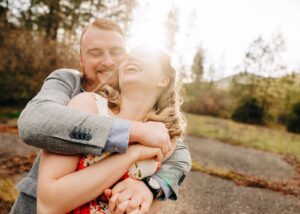 Missoula couple laughing together at Lincolnwood Trailhead in Missoula, MT