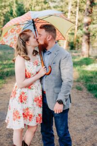 Missoula couple kissing under colorful umbrella