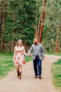 Engagement photo of Missoula couple walking hand in hand at Lincolnwood Trailhead