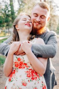 Engaged couple embracing outside in the forest in Missoula, MT