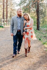 Spring engagement picture Missoula couple walking in forest
