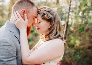 Missoula couple intimate embrace in forest during springtime