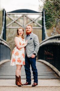 Missoula couple posing at Lincolnwood Trailhead suspension footbridge