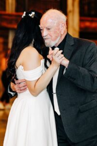 Intimate father-daughter dance during indoor wedding reception at Snowline Acres in Kalispell, MT