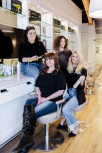 Brand portrait of the Missoula Drybar hair stylists styling each others hair