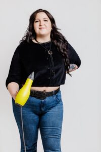 Missoula Drybar hair stylist posing with yellow hair dryer