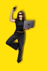 Brand photo of Missoula Drybar salon manager balancing on one leg with cell phone and laptop