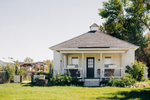 McVey Homestead farmhouse with green lawn and trees