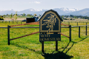 McVey Homestead property sign with Bitterroot Mountains in background