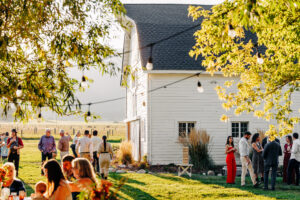 Guests and barn at outdoor wedding reception at McVey Homestead