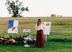 Guest painting at plein air setup at McVey Homestead wedding venue in Victor, Montana