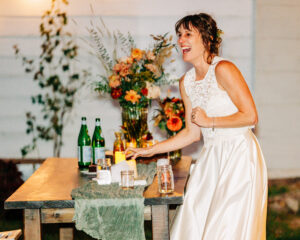 Bride smiling at evening wedding reception at Homestead on McVey in Victor, MT