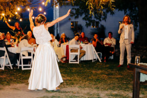 Groom singing to bride at McVey Homestead wedding reception at blue hour