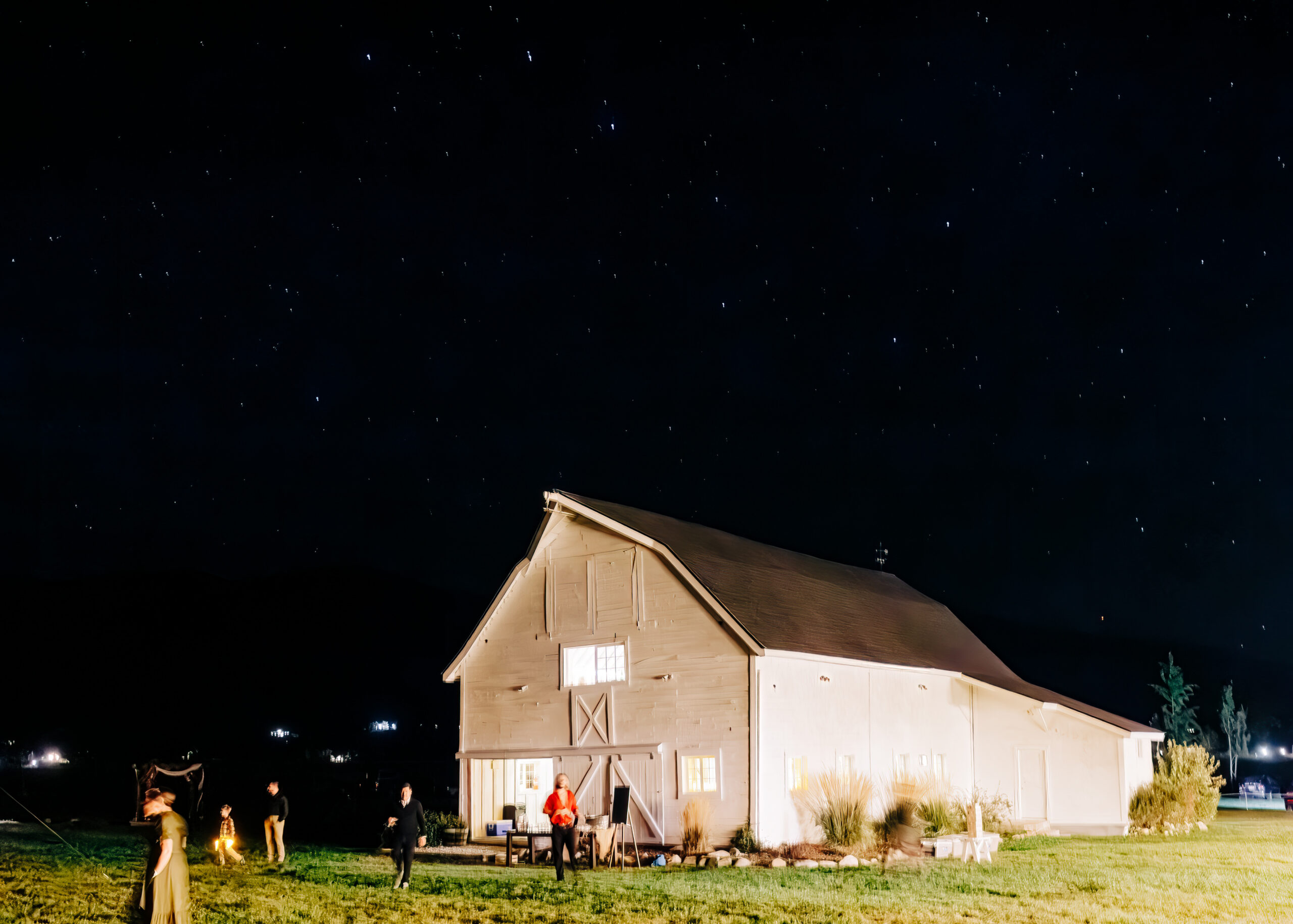 Starry night sky over white barn at McVey Homestead wedding venue in Victor, MT