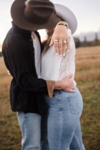 Montana woman kissing fiance and holding engagement ring out to the camera